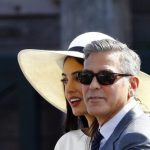 U.S. actor George Clooney and his wife Amal Alamuddin leave Venice city hall after a civil ceremony to formalize their wedding in Venice