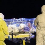 Health workers load Spanish Ebola patient, Catholic priest Garcia Viejo, into an ambulance on the tarmac of Torrejon airbase