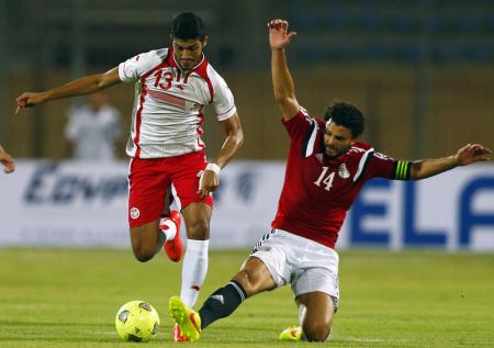 Egypt's Hossam Ghali fights for the ball with Ferjani Sassi of Tunisia during their African Nations Cup qualifying soccer match in Cairo