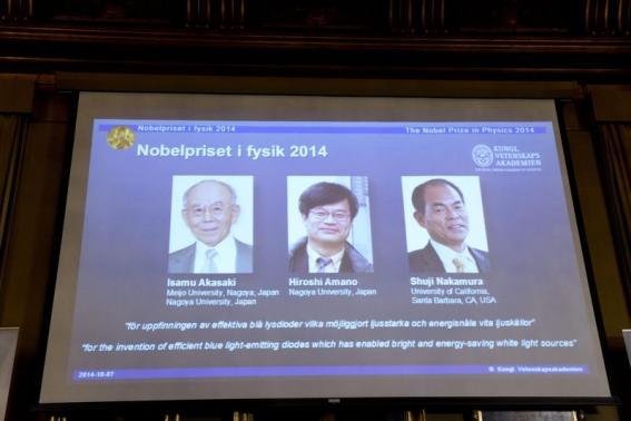 Japanese scientists Akasaki and Amano, and U.S. scientist Nakamura are seen on a screen after being announced as the 2014 Nobel Physics Laureates in Stockholm