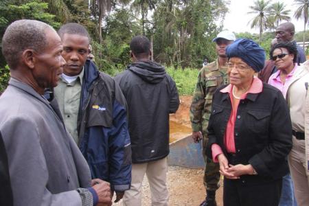Liberian President Ellen Johnson-Sirleaf speaks to villagers about Ebola virus precautions outside Ganta