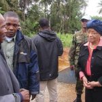 Liberian President Ellen Johnson-Sirleaf speaks to villagers about Ebola virus precautions outside Ganta