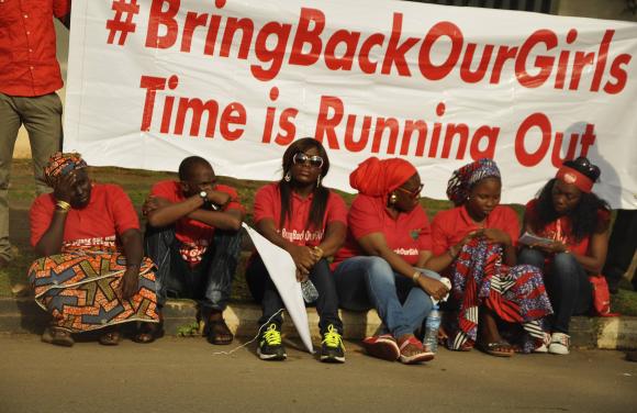 Members of Abuja "Bring Back Our Girls" protest group sit during a protest march, organized by the group to the Presidential Villa, in Abuja