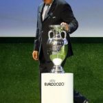 UEFA President Platini touches the trophy after the announcement of the 13 cities which will host matches at the Euro 2020 tournament to be played across the continent, during a ceremony in Geneva