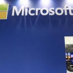 A employee stands in the Microsoft booth during the 2014 Computex exhibition at the TWTC Nangang exhibition hall in Taipei