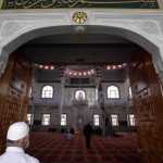 Muslim worshippers walk into the Gallipoli Mosque to pray in the western Sydney suburb of Auburn
