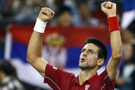 Novak Djokovic of Serbia celebrates winning his men's singles tennis match against David Ferrer of Spain at the Shanghai Masters tennis tournament in Shanghai