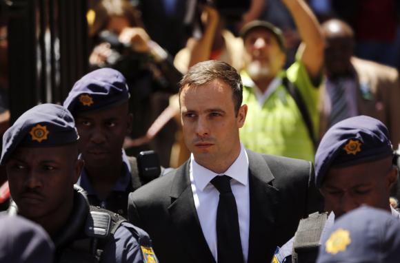 South African Olympic and Paralympic sprinter Oscar Pistorius leaves the North Gauteng High Court in Pretoria