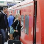 Passengers ask for information from a train driver of German railways, Deutsche Bahn (DB) at the railways station of the Cologne-Bonn airport