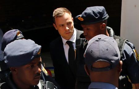 South African Olympic and Paralympic sprinter Pistorius is escorted to a police van after his sentencing at the North Gauteng High Court in Pretoria