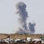 Smoke rises from the Syrian town of Kobani after a war plane carried out an air strike, seen from near the Mursitpinar border crossing on the Turkish-Syrian border in Suruc