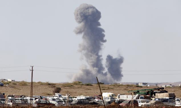 Smoke rises from the Syrian town of Kobani after a war plane carried out an air strike, seen from near the Mursitpinar border crossing on the Turkish-Syrian border in Suruc