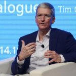 Apple CEO Tim Cook gestures as he speaks at Tsinghua University in Beijing