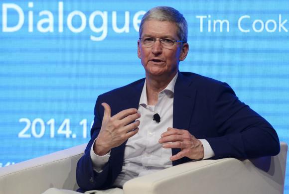 Apple CEO Tim Cook gestures as he speaks at Tsinghua University in Beijing