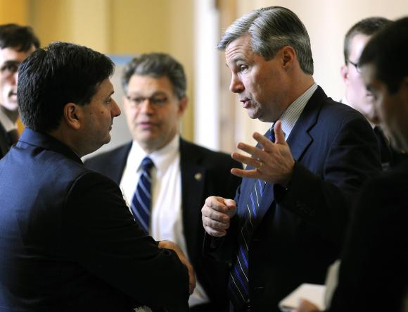 File photo of U.S. Senator Whitehouse talking to Klain, then-Chief of Staff for U.S. Vice President Biden, in Washington