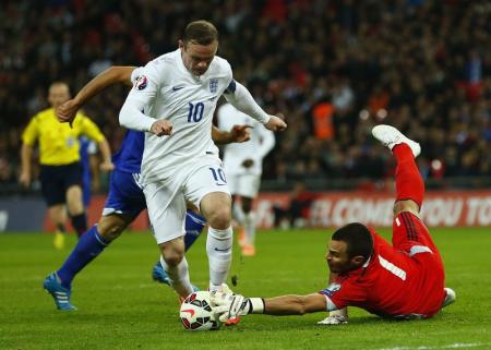 England's Wayne Rooney is denied by San Marino's Davide Simoncini during their Euro 2016 qualifying soccer match at Wembley Stadium in London