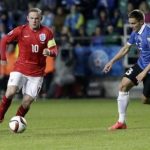Estonia's Vunk challenges England's Rooney during their Euro 2016 qualifying soccer match at the A. Le Coq Arena in Tallinn