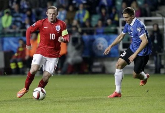 Estonia's Vunk challenges England's Rooney during their Euro 2016 qualifying soccer match at the A. Le Coq Arena in Tallinn