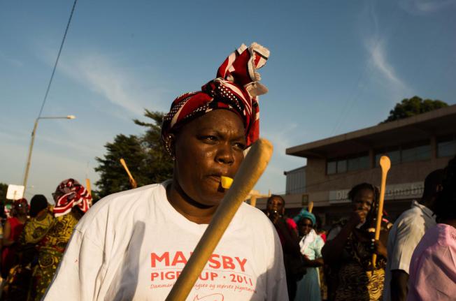 Woman holding a wooden spoon protest