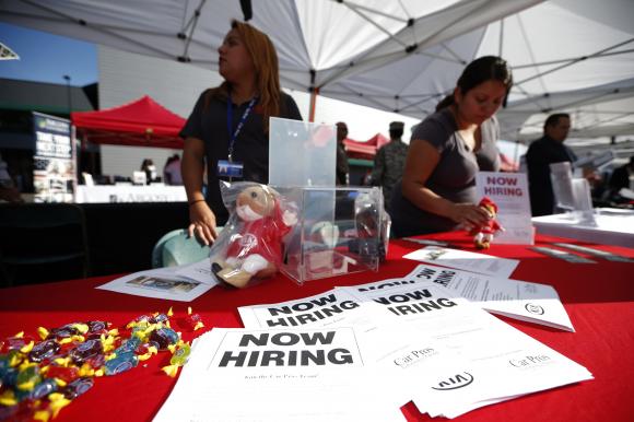 Recruiters wait at a booth at a military veterans' job fair in Carson