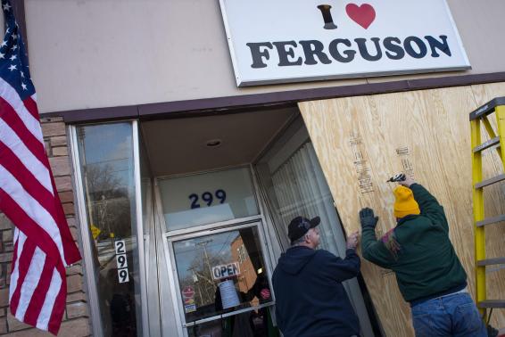 Volunteers board up the "I Love Ferguson" headquarters in preparation for the grand jury verdict in the shooting death of Michael Brown