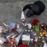 A man leaves flowers