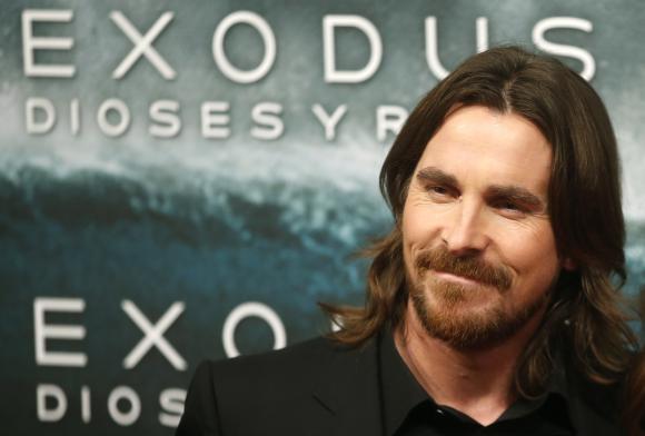 Christian Bale poses for photographs as he arrives for the film world premiere of "Exodus: Gods and Kings" in Madrid