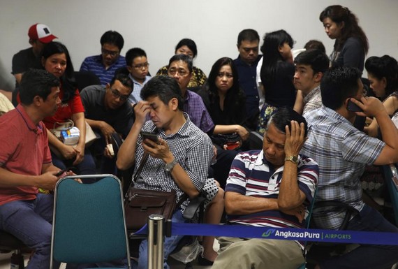 Family members of passengers onboard AirAsia flight QZ8501 react at a waiting area in Surabaya's Juanda International Airport