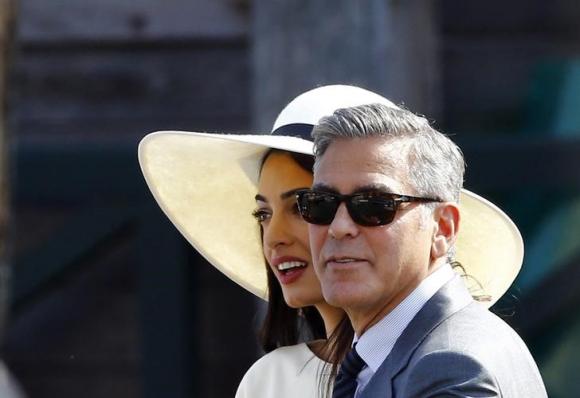 U.S. actor George Clooney and his wife Amal Alamuddin leave Venice city hall after a civil ceremony to formalize their wedding in Venice
