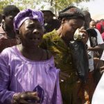 Mourners cry during funeral service for six people killed during popular uprising of October 30 and 31 in Ouagadougou
