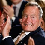 Former President George H. W. Bush applauds during an event to honor the winner of the 5,000th Daily Point of Light Award at the White House in Washington in this file photo