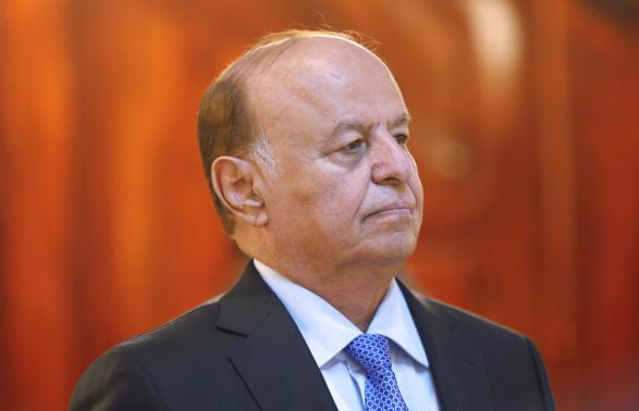 File photo of Yemen's President Hadi stands attending a reception during the holy fasting month of Ramadan at the Republican Palace in Sanaa