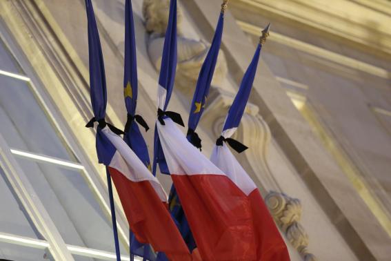 French flags are tied with black tissue at the Elysee Palace in a sign of mourning in Paris