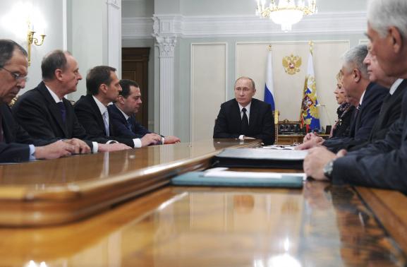 Russian President Vladimir Putin chairs a meeting with members of the Security Council at the Novo-Ogaryovo state residence outside Moscow