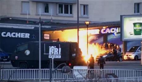 police officers storm a kosher grocery to end a hostage situation in Paris