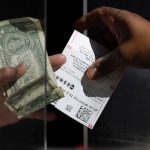 A woman buys a Powerball ticket