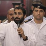 Activist Alaa Abdel Fattah speaks in front of a judge at a court during his trial in Cairo
