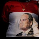 An Egyptian Christian woman wearing a shirt with the photo of Egyptian President Abdel Fattah el-Sissi