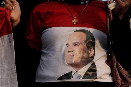 An Egyptian Christian woman wearing a shirt with the photo of Egyptian President Abdel Fattah el-Sissi