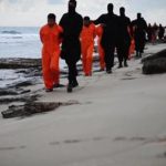 Still image from video shows men purported to be Egyptian Christians held captive by the Islamic State being marched by armed men along a beach said to be near Tripoli