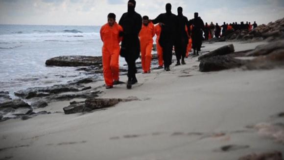 Still image from video shows men purported to be Egyptian Christians held captive by the Islamic State being marched by armed men along a beach said to be near Tripoli