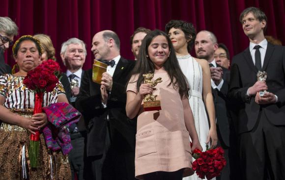 The niece of Iranian film director Panahi appears on stage with jury members and prize winners during awards ceremony at 65th Berlinale International Film Festival in Berlin