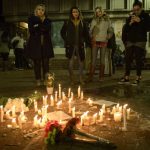 People before a makeshift memorial after a vigil at the University of North Carolina