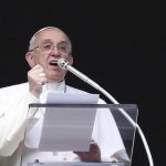Pope Francis reacts as he conducts his Sunday Angelus prayer in Saint Peter's square at the Vatican