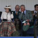 Britain's Queen Elizabeth and Prince Charles watch the sack race at the annual Braemar Highland Gathering in Braemar, Scotland