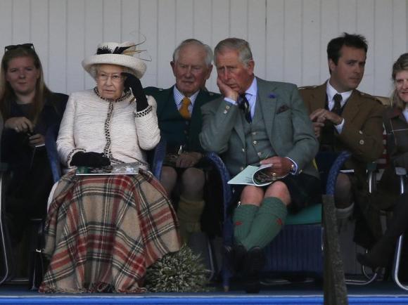 Britain's Queen Elizabeth and Prince Charles watch the sack race at the annual Braemar Highland Gathering in Braemar, Scotland