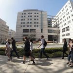 People walk past the entrance to the Ronald Reagan UCLA Medical Center in Los Angeles, California