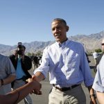 U.S. President Obama extends his hand to greet a well-wisher upon his arrival in Palm Springs