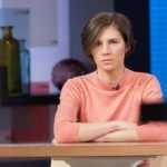 Amanda Knox sits alone before being interviewed on the set of ABC's "Good Morning America" in New York
