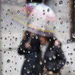 People walking under an umbrella